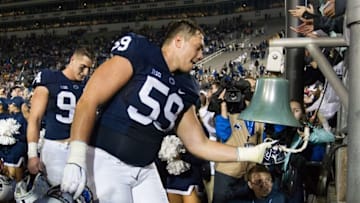 Oct 1, 2016; University Park, PA, USA; Penn State Nittany Lions tackle Andrew Nelson (59) rings the victory bell following the conclusion of the overtime game against the Minnesota Golden Gophers at Beaver Stadium. Penn State defeated Minnesota 29-26 in overtime. Mandatory Credit: Matthew O