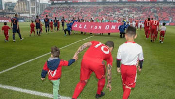 May 18, 2016; Toronto, Ontario, CAN; Toronto FC forward Sebastian Giovinco (10) walks onto the pitch with a player escort and his son before a game against New York City FC at BMO Field. The game ended in a 1-1 draw. Mandatory Credit: Nick Turchiaro-USA TODAY Sports