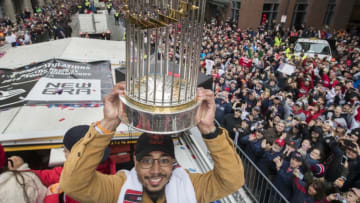 BOSTON, MA - OCTOBER 31: Red Sox Mookie Betts hoists the World Series Trophy on the Rolling Rally Parade in Boston on Oct. 31, 2018. (Photo by Stan Grossfeld/The Boston Globe via Getty Images)