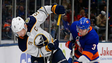 Dec 14, 2019; Uniondale, NY, USA; New York Islanders defenseman Adam Pelech (3) and Buffalo Sabres center Jack Eichel (9) battle for a position during the first period at Nassau Veterans Memorial Coliseum. Mandatory Credit: Andy Marlin-USA TODAY Sports