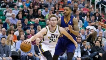 Feb 26, 2014; Salt Lake City, UT, USA; Utah Jazz shooting guard Gordon Hayward (20) is fouled by Phoenix Suns power forward Marcus Morris (15) during the second half at EnergySolutions Arena. The Jazz won 109-86. Mandatory Credit: Russ Isabella-USA TODAY Sports