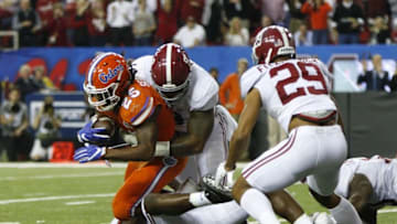 Dec 3, 2016; Atlanta, GA, USA; Florida Gators running back Jordan Scarlett (25) is brought down by Alabama Crimson Tide defensive lineman Da'Shawn Hand (9) during the third quarter of the SEC Championship college football game at Georgia Dome. Mandatory Credit: Brett Davis-USA TODAY Sports