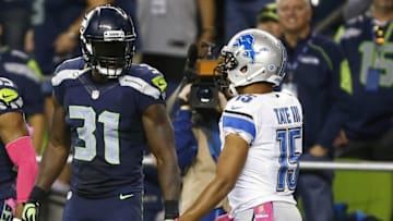 Oct 5, 2015; Seattle, WA, USA; Seattle Seahawks strong safety Kam Chancellor (31) talks with Detroit Lions wide receiver Golden Tate (15) after making a pass defense during the third quarter at CenturyLink Field. Seattle defeated Detroit, 13-10. Mandatory Credit: Joe Nicholson-USA TODAY Sports
