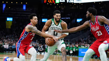 Dec 20, 2021; Boston, Massachusetts, USA; Philadelphia 76ers forward Danny Green (14) and center Joel Embiid (21) defend against Boston Celtics forward Jayson Tatum (0) in the second half at TD Garden. Mandatory Credit: David Butler II-USA TODAY Sports