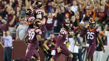 LANDOVER, MD - SEPTEMBER 03: Virginia Tech Hokies defensive end Vinny Mihota (99) and Virginia Tech Hokies guard Wyatt Teller (57) celebrate at games end during a college football game between the West Virginia Mountaineers and the Virginia Tech Hokies on September 3, 2017, at Fedex Field, in Landover, MD. Virginia Tech defeated West Virginia 31-24. (Photo by Tony Quinn/Icon Sportswire via Getty Images)