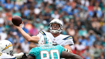 CARSON, CA - SEPTEMBER 17: Quarterback Philip Rivers #17 of the Los Angeles Chargers throws under pressure by defensive end Charles Harris #90 of the Miami Dolphins during the first half of their NFL game at the StubHub Center September 17, 2017, in Carson, California. (Photo by Kevork Djansezian/Getty Images)