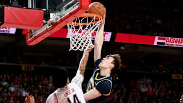 COLLEGE PARK, MD - MARCH 03: Colin Castleton #11 of the Michigan Wolverines dunks the ball against Ricky Lindo Jr. #14 of the Maryland Terrapins at Xfinity Center on March 3, 2019 in College Park, Maryland. (Photo by G Fiume/Maryland Terrapins/Getty Images)