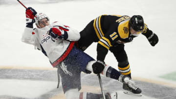 Mar 3, 2021; Boston, Massachusetts, USA; Boston Bruins center Trent Frederic (11) knocks down Washington Capitals right wing Tom Wilson (43) during the second period at TD Garden. Mandatory Credit: Winslow Townson-USA TODAY Sports