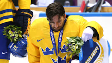 SOCHI, RUSSIA - FEBRUARY 23: Silver medalist Henrik Lundqvist #30 of Sweden reacts during the medal ceremony after losing to Canada 3-0 during the Men's Ice Hockey Gold Medal match on Day 16 of the 2014 Sochi Winter Olympics at Bolshoy Ice Dome on February 23, 2014 in Sochi, Russia. (Photo by Bruce Bennett/Getty Images)