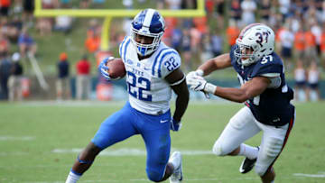 CHARLOTTESVILLE, VA - OCTOBER 7: Brittain Brown #22 of the Duke Blue Devils rushes as he is chased down by Jordan Mack #37 of the Virginia Cavaliers during a game at Scott Stadium on October 7, 2017 in Charlottesville, Virginia. (Photo by Ryan M. Kelly/Getty Images)
