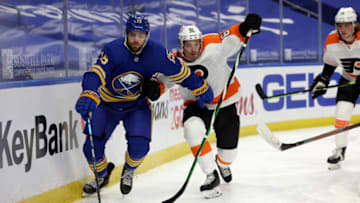 Mar 29, 2021; Buffalo, New York, USA; Buffalo Sabres center Jean-Sebastien Dea (15) and Philadelphia Flyers defenseman Justin Braun (61) skate after a loose puck during the second period at KeyBank Center. Mandatory Credit: Timothy T. Ludwig-USA TODAY Sports