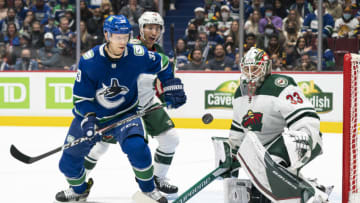 VANCOUVER, BC - OCTOBER 26: Alex Chiasson #39 of the Vancouver Canucks and Jared Spurgeon #46 of the Minnesota Wild eye the loose puck after goalie Cam Talbot #33 of the Minnesota Wild made a save during the second period of NHL action on October, 26, 2021 at Rogers Arena in Vancouver, British Columbia, Canada. (Photo by Rich Lam/Getty Images)