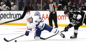 LOS ANGELES, CALIFORNIA - MARCH 05: Mitchell Marner #16 of the Toronto Maple Leafs lunges for the puck against Dustin Brown #23 of the Los Angeles Kings during the third period at Staples Center on March 05, 2020 in Los Angeles, California. (Photo by Katelyn Mulcahy/Getty Images)