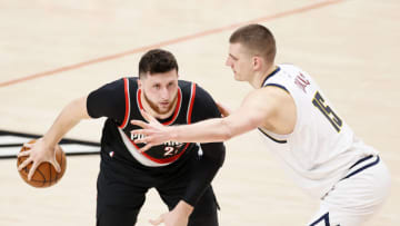 PORTLAND, OREGON - MAY 29: Jusuf Nurkic #27 of the Portland Trail Blazers controls the ball as Nikola Jokic #15 of the Denver Nuggets defends in the first quarter during Round 1, Game 4 of the 2021 NBA Playoffs at Moda Center on May 29, 2021 in Portland, Oregon. NOTE TO USER: User expressly acknowledges and agrees that, by downloading and or using this photograph, User is consenting to the terms and conditions of the Getty Images License Agreement. (Photo by Steph Chambers/Getty Images)