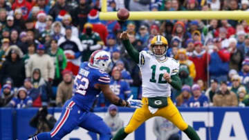 Dec 14, 2014; Orchard Park, NY, USA; Green Bay Packers quarterback Aaron Rodgers (12) throws a pass as Buffalo Bills outside linebacker Preston Brown (52) defends during the first half at Ralph Wilson Stadium. Mandatory Credit: Kevin Hoffman-USA TODAY Sports