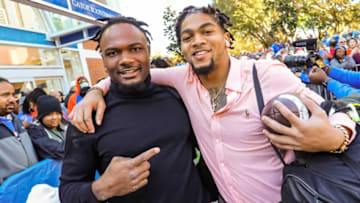 Florida Gators running back Dameon Pierce (27) and Florida Gators running back Malik Davis (20) grab a photo as the Florida Gators arrived for Gator Walk Saturday November 27, 2021 as they enter Ben Hill Griffin Stadium in Gainesville, Florida. [Doug Engle/Ocala Star-Banner]2021Flgai 112721 Ufvsfsu Fb