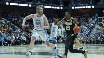 Nov 20, 2021; Uncasville, Connecticut, USA; Purdue Boilermakers guard Jaden Ivey (23) dribbles the ball toward the basket with North Carolina Tarheels forward Brady Manek (45) defending during the second half at Mohegan Sun Arena. Mandatory Credit: Gregory Fisher-USA TODAY Sports