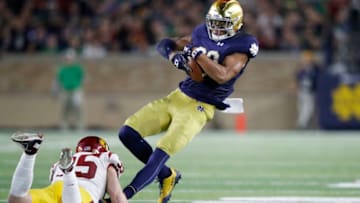 SOUTH BEND, IN - OCTOBER 21: Chase Claypool #83 of the Notre Dame Fighting Irish tries to break a tackle after a catch against Cameron Smith #35 of the USC Trojans in the third quarter of a game at Notre Dame Stadium on October 21, 2017 in South Bend, Indiana. Notre Dame won 49-14. (Photo by Joe Robbins/Getty Images)