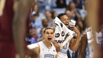 Jan 30, 2016; Chapel Hill, NC, USA; North Carolina Tar Heels guards Marcus Paige (5) and Nate Britt (0) react at the end of the game. The Tar Heels defeated the Eagles 89-62 at Dean E. Smith Center. Mandatory Credit: Bob Donnan-USA TODAY Sports