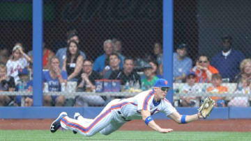 Jul 31, 2016; New York City, NY, USA; New York Mets left fielder Brandon Nimmo (9) dives for the ball hit by Colorado Rockies center fielder Charlie Blackmon (19) (not pictured) for an out during the first inning at Citi Field. Mandatory Credit: Anthony Gruppuso-USA TODAY Sports