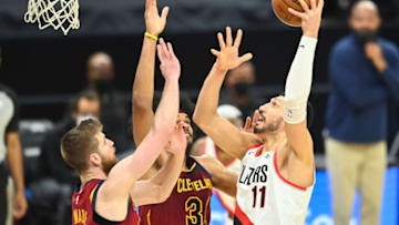 May 5, 2021; Cleveland, Ohio, USA; Portland Trail Blazers center Enes Kanter (11) shoots over the defense of Cleveland Cavaliers forward Dean Wade (32) and center Jarrett Allen (31) during the third quarter at Rocket Mortgage FieldHouse. Mandatory Credit: Ken Blaze-USA TODAY Sports