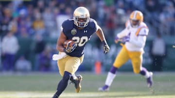NASHVILLE, TN - DECEMBER 30: C.J. Prosise #20 of the Notre Dame Fighting Irish runs with the ball against the LSU Tigers during the Franklin American Mortgage Music City Bowl at LP Field on December 30, 2014 in Nashville, Tennessee. (Photo by Andy Lyons/Getty Images)