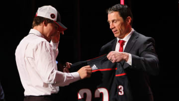 NASHVILLE, TENNESSEE - JUNE 28: Head coach Rod Brind'Amour of the Carolina Hurricanes presents Bradly Nadeau with a jersey after being selected with the 30th overall pick during round one of the 2023 Upper Deck NHL Draft at Bridgestone Arena on June 28, 2023 in Nashville, Tennessee. (Photo by Bruce Bennett/Getty Images)