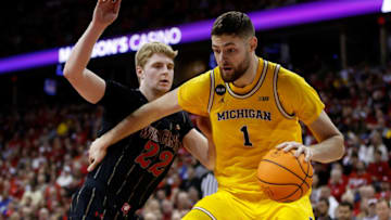 MADISON, WISCONSIN - FEBRUARY 14: Hunter Dickinson #1 of the Michigan Wolverines drives to the basket on Steven Crowl #22 of the Wisconsin Badgers during the first half of the game at Kohl Center on February 14, 2023 in Madison, Wisconsin. (Photo by John Fisher/Getty Images)