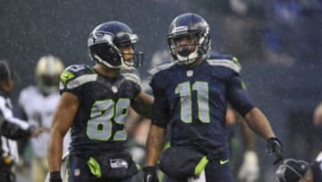 Jan 11, 2014; Seattle, WA, USA; Seattle Seahawks wide receiver Percy Harvin (11) is congratulated by wide receiver Doug Baldwin (89) for catching a pass against the New Orleans Saints during the first half of the 2013 NFC divisional playoff football game at CenturyLink Field. Mandatory Credit: Steven Bisig-USA TODAY Sports