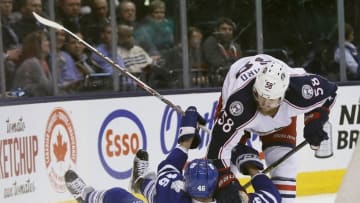 Apr 6, 2016; Toronto, Ontario, CAN; Columbus Blue Jackets defenseman David Savard (58) knocks down Toronto Maple Leafs forward Tobias Lindberg (46) during the second period at the Air Canada Centre. Mandatory Credit: John E. Sokolowski-USA TODAY Sports