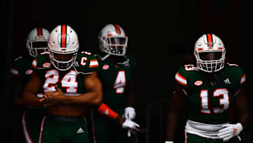 MIAMI, FL - OCTOBER 06: Travis Homer #24, Jeff Thomas #4, and DeeJay Dallas #13 of the Miami Hurricanes take the field before the game against the Florida State Seminoles at Hard Rock Stadium on October 6, 2018 in Miami, Florida. (Photo by Mark Brown/Getty Images)