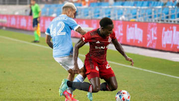 Aug 7, 2021; Toronto, Ontario, CAN; Toronto FC midfielder Richie Laryea (22) battles for the ball against New York City midfielder Santiago Rodriguez (42) during the second half at BMO Field. Mandatory Credit: Nick Turchiaro-USA TODAY Sports