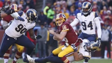 Dec 7, 2014; Landover, MD, USA; Washington Redskins quarterback Colt McCoy (16) is sacked by St. Louis Rams middle linebacker James Laurinaitis (55) in the second quarter at FedEx Field. Mandatory Credit: Geoff Burke-USA TODAY Sports