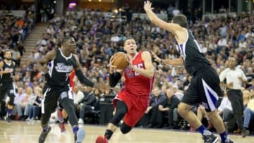 Oct 28, 2015; Sacramento, CA, USA; Los Angeles Clippers guard Austin Rivers (25) drives in between Sacramento Kings guard Darren Collison (7) and forward Omri Casspi (18) during the second quarter at Sleep Train Arena. Mandatory Credit: Kelley L Cox-USA TODAY Sports