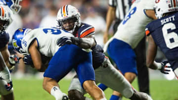 Auburn football linebacker Owen Pappoe (0) tackles San Jose State Spartans running back Kairee Robinson (32) as Auburn Tigers take on San Jose State Spartans at Jordan-Hare Stadium in Auburn, Ala., on Saturday, Sept. 10, 2022. Auburn Tigers defeated San Jose State Spartans 24-16.