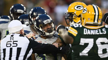 GREEN BAY, WI - DECEMBER 11: Referees separate Thomas Rawls #34 of the Seattle Seahawks from Green Bay Packers defenders during the first half of a game at Lambeau Field on December 11, 2016 in Green Bay, Wisconsin. (Photo by Stacy Revere/Getty Images)