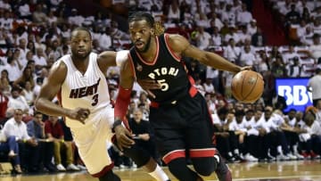 May 7, 2016; Miami, FL, USA; Toronto Raptors forward DeMarre Carroll (5) dribbles the ball past Miami Heat guard Dwyane Wade (3) during the first quarter in game three of the second round of the NBA Playoffs at American Airlines Arena. Mandatory Credit: Steve Mitchell-USA TODAY Sports