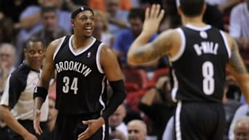 Mar 12, 2014; Miami, FL, USA; Brooklyn Nets forward Paul Pierce (left) reacts with teammate guard Deron Williams (right) during the first half against the Miami Heat at American Airlines Arena. Mandatory Credit: Steve Mitchell-USA TODAY Sports