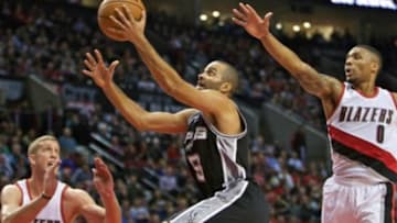 Nov 11, 2015; Portland, OR, USA; San Antonio Spurs guard Tony Parker (9) shoots over Portland Trail Blazers guard Damian Lillard (0) during the fourth quarter at the Moda Center. Mandatory Credit: Craig Mitchelldyer-USA TODAY Sports