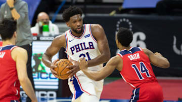 Jan 6, 2021; Philadelphia, Pennsylvania, USA; Philadelphia 76ers center Joel Embiid (21) handles the ball against Washington Wizards guard Ish Smith (14) during the third quarter at Wells Fargo Center. Mandatory Credit: Bill Streicher-USA TODAY Sports