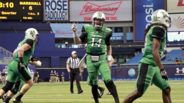Dec 26, 2015; St. Petersburg, FL, USA; Marshall Thundering Herd quarterback Chase Litton (14) celebrates as they score a touchdown against the Connecticut Huskies during the first quarter at Tropicana Field. Mandatory Credit: Kim Klement-USA TODAY Sports
