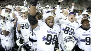 IOWA CITY, IOWA- NOVEMBER 10: Defensive lineman Jordan Thompson #99 of the Northwestern Wildcats joins teammates in singing their fight song after they defeated the Iowa Hawkeyes, on November 10, 2018 at Kinnick Stadium, in Iowa City, Iowa. (Photo by Matthew Holst/Getty Images)