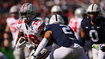 STATE COLLEGE, PA - OCTOBER 29: Marvin Harrison Jr. #18 of the Ohio State Buckeyes carries the ball as Keaton Ellis #2 of the Penn State Nittany Lions defends during the first half at Beaver Stadium on October 29, 2022 in State College, Pennsylvania. (Photo by Scott Taetsch/Getty Images)
