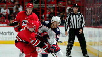 RALEIGH, NC - OCTOBER 10: Derek Ryan #7 of the Carolina Hurricanes and Alexander Wennberg #10 of the Columbus Blue Jackets struggle for possession of the puck during an NHL game on October 10, 2017 at PNC Arena in Raleigh, North Carolina. (Photo by Gregg Forwerck/NHLI via Getty Images)