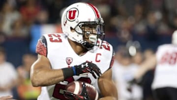 Nov 14, 2015; Tucson, AZ, USA; Utah Utes running back Devontae Booker (23) runs the ball against the Arizona Wildcats during the first quarter at Arizona Stadium. Mandatory Credit: Casey Sapio-USA TODAY Sports