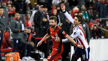 TORONTO, ON - APRIL 17: Drew Moor #3 of Toronto FC controls the ball past Isac Brizuela #11 of Chivas Guadalajara during the CONCACAF Champions League Final Leg 1 on April 17, 2018 at BMO Field in Toronto, Ontario, Canada. (Photo by Graig Abel/Getty Images)