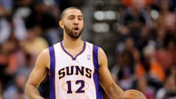 Apr 7, 2013; Phoenix, AZ, USA; Phoenix Suns guard Kendall Marshall (12) dribbles the ball up the court against the New Orleans Hornets in the first half at US Airways Center. Mandatory Credit: Jennifer Stewart-USA TODAY Sports