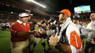 Dec 31, 2015; Miami Gardens, FL, USA; Clemson Tigers head coach Dabo Swinney shakes hands with Oklahoma Sooners head coach Bob Stoops during the fourth quarter of the 2015 CFP semifinal at the Orange Bowl at Sun Life Stadium. Clemson won 37-17. Mandatory Credit: Steve Mitchell-USA TODAY Sports