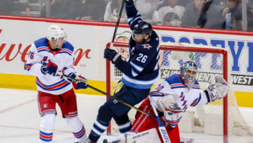 WINNIPEG, MB - FEBRUARY 11: Brady Skjei #76 of the New York Rangers watches as Blake Wheeler #26 of the Winnipeg Jets falls on goaltender Henrik Lundqvist #30 during second period action at the Bell MTS Place on February 11, 2018 in Winnipeg, Manitoba, Canada. The Rangers defeated the Jets 3-1. (Photo by Jonathan Kozub/NHLI via Getty Images)