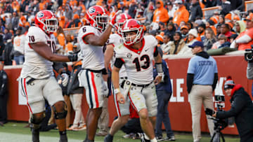 Stetson Bennett celebrates with teammates after scoring a touchdown against Tennessee. (Photo by Dylan Buell/Getty Images)